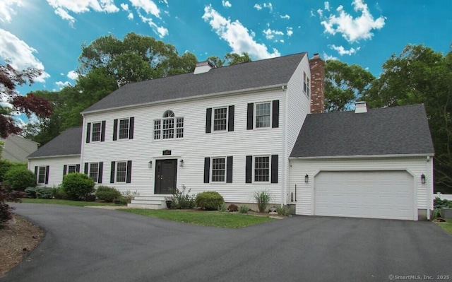 30 Valley Brook Rd S, Branford, CT 06405 - colonial home featuring a chimney, an attached garage, and asphalt driveway