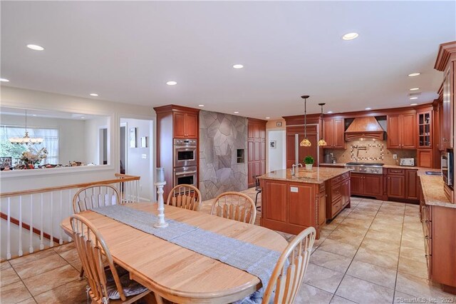 dining room with light tile patterned floors and a notable chandelier