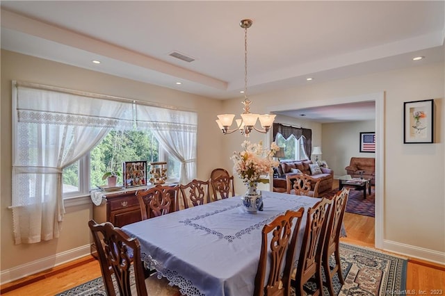 dining room featuring a chandelier and light hardwood / wood-style flooring