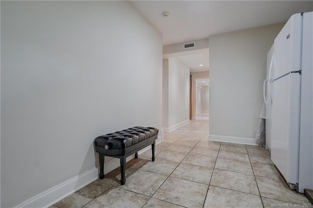 corridor with light tile patterned flooring