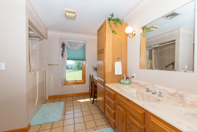 bathroom with tile floors and vanity