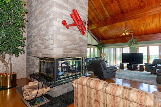 living room featuring a stone fireplace, ceiling fan, wood-type flooring, and wooden ceiling