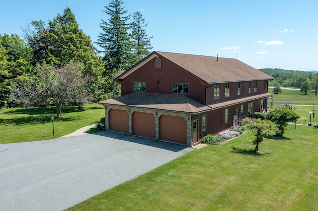 view of front of property with a front lawn and a garage