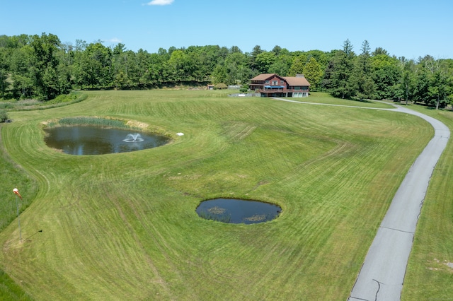 surrounding community with a water view, a rural view, and a lawn