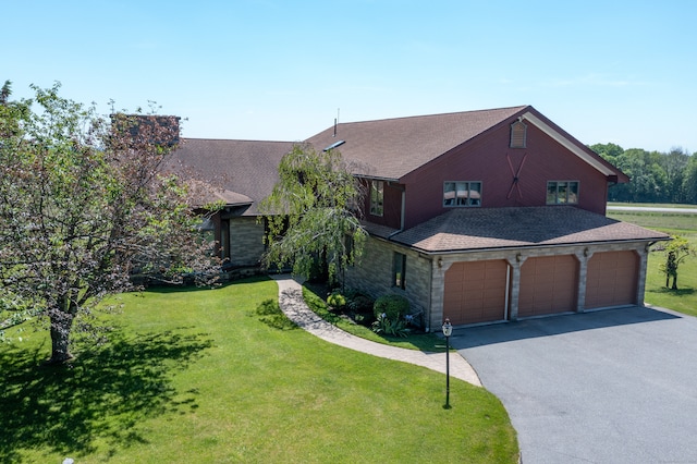 view of front of home featuring a garage and a front yard