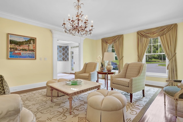 sitting room with an inviting chandelier, crown molding, and light hardwood / wood-style flooring