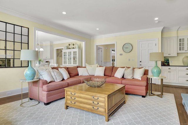 living room with crown molding and light wood-type flooring