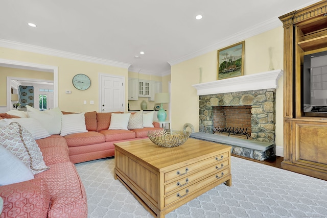 living room featuring ornamental molding, a fireplace, and light hardwood / wood-style flooring