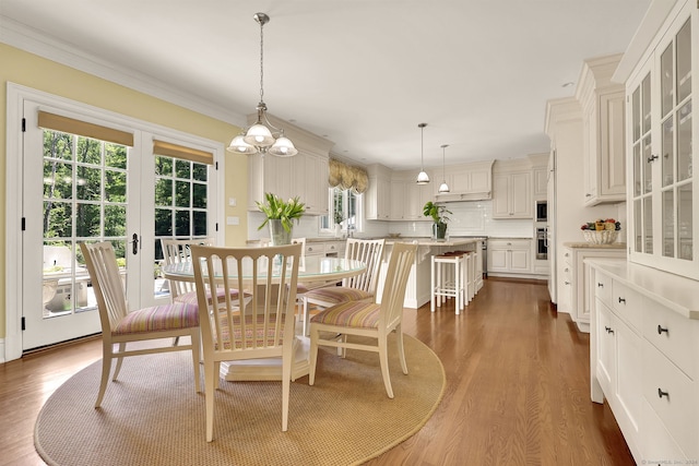 dining room featuring crown molding and dark hardwood / wood-style floors