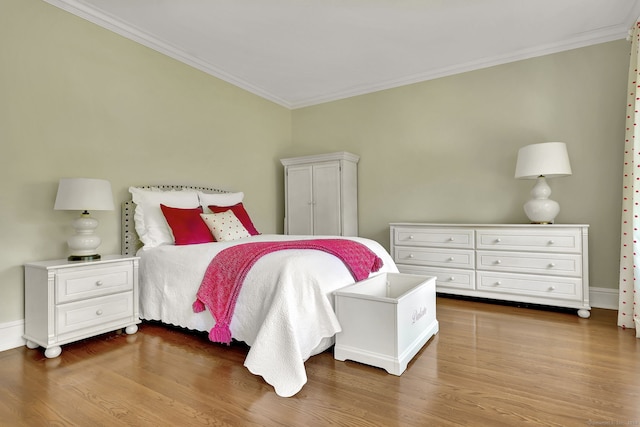 bedroom featuring crown molding and dark hardwood / wood-style floors