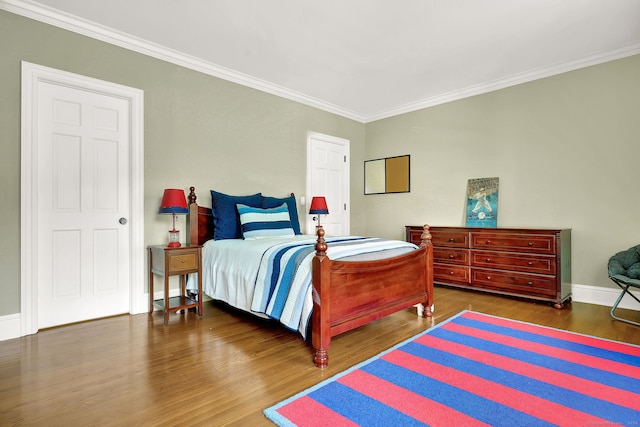 bedroom with crown molding and dark hardwood / wood-style flooring