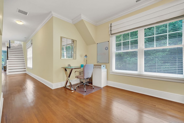 unfurnished office with hardwood / wood-style flooring, ornamental molding, and plenty of natural light