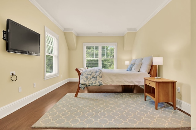 bedroom with ornamental molding and dark hardwood / wood-style flooring