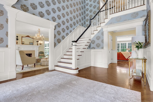 stairway featuring parquet flooring and a notable chandelier