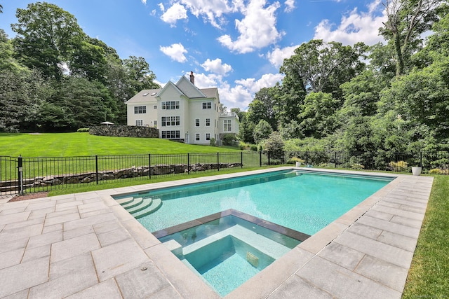 view of pool with an in ground hot tub and a yard