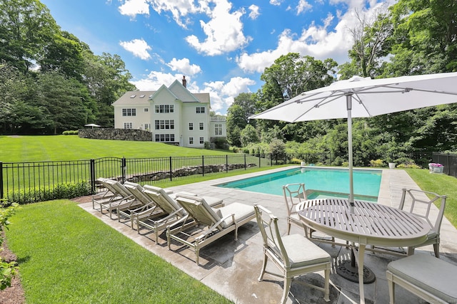 view of pool featuring a patio and a yard