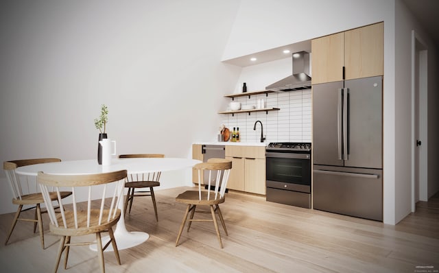 kitchen with sink, stainless steel appliances, wall chimney range hood, light hardwood / wood-style flooring, and backsplash