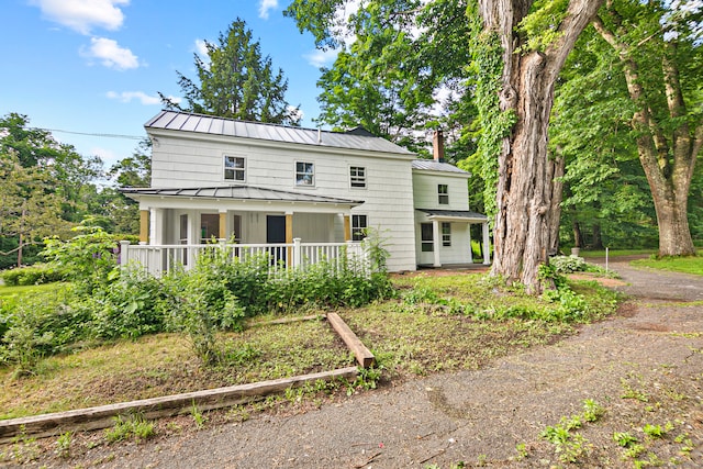 back of property featuring a porch