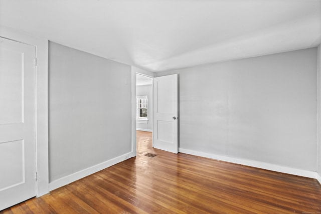 spare room featuring dark hardwood / wood-style floors