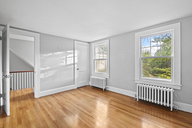 unfurnished room with light wood-type flooring and radiator