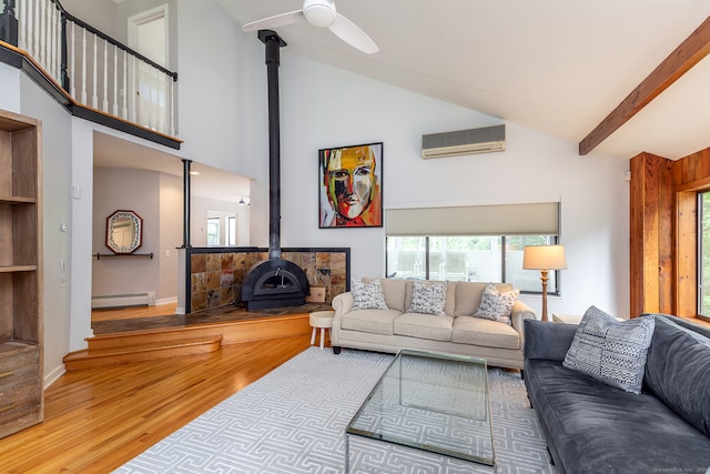 living room with wood-type flooring, a wall unit AC, a wood stove, a baseboard radiator, and ceiling fan