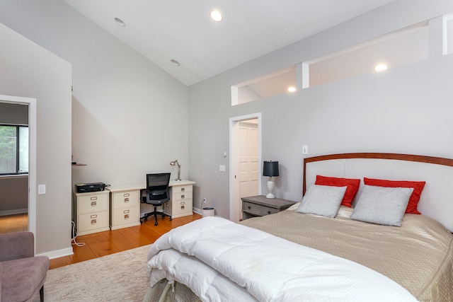 bedroom with lofted ceiling and light hardwood / wood-style flooring