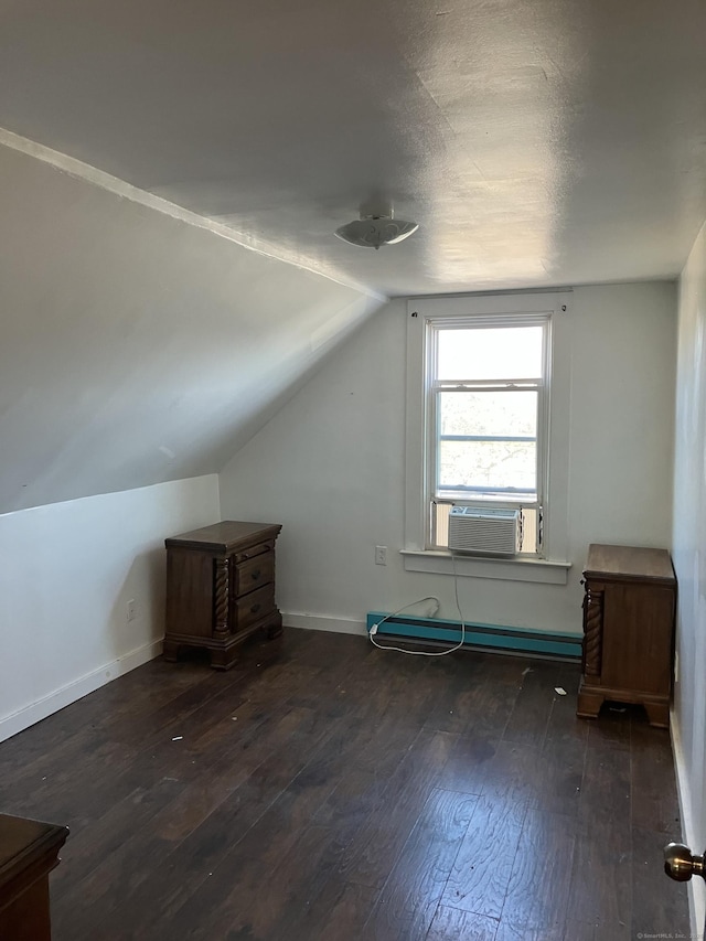 bonus room featuring dark wood-type flooring, baseboard heating, vaulted ceiling, and cooling unit