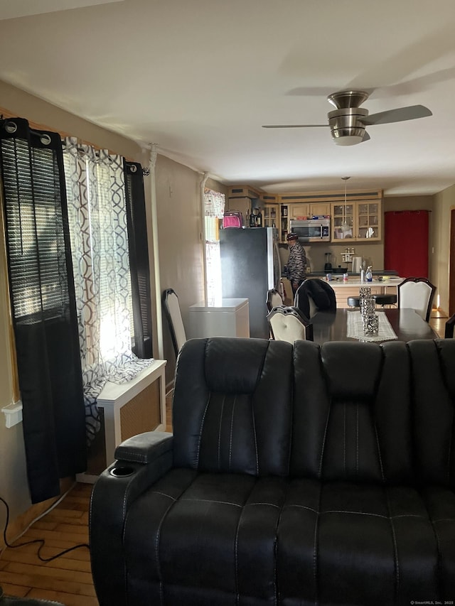 living room featuring hardwood / wood-style flooring and ceiling fan