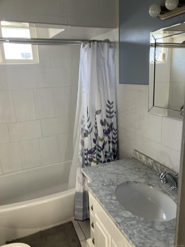 full bathroom featuring vanity, tile walls, shower / tub combo, and toilet