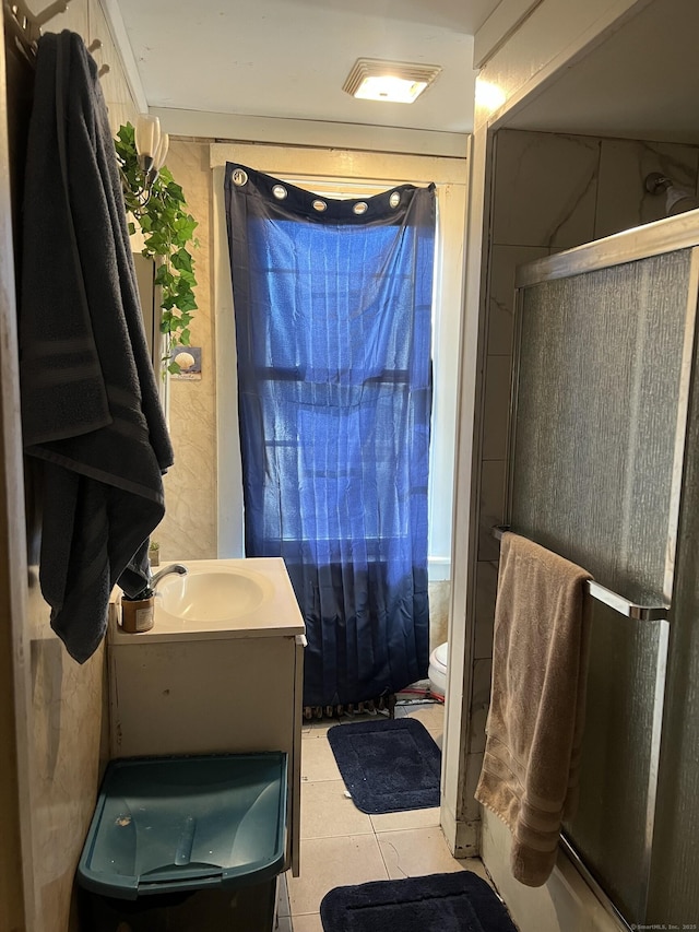 bathroom featuring walk in shower, tile patterned floors, vanity, and toilet