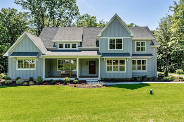 craftsman-style house featuring covered porch and a front lawn