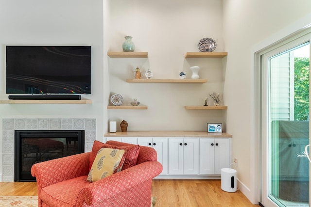 sitting room featuring a fireplace and light hardwood / wood-style flooring