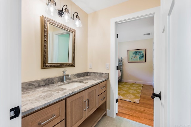 bathroom with vanity, hardwood / wood-style flooring, and toilet