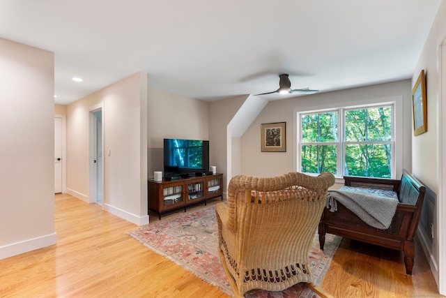 living room featuring ceiling fan and light wood-type flooring