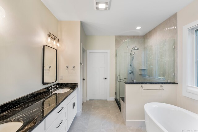 bathroom featuring shower with separate bathtub and vanity