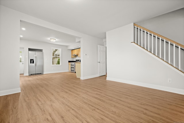 unfurnished living room with light hardwood / wood-style floors