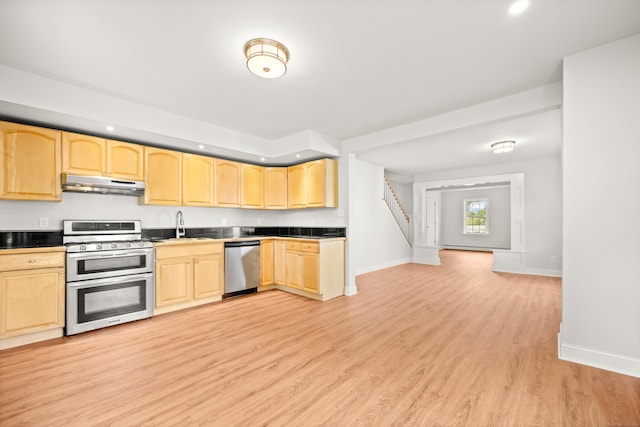 kitchen featuring sink, stainless steel appliances, light hardwood / wood-style flooring, and light brown cabinets