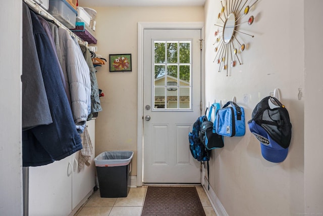 doorway to outside with light tile patterned floors