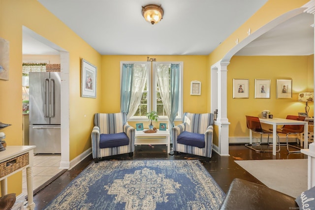 sitting room with wood-type flooring and ornate columns