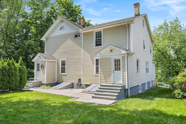 back of house featuring a yard