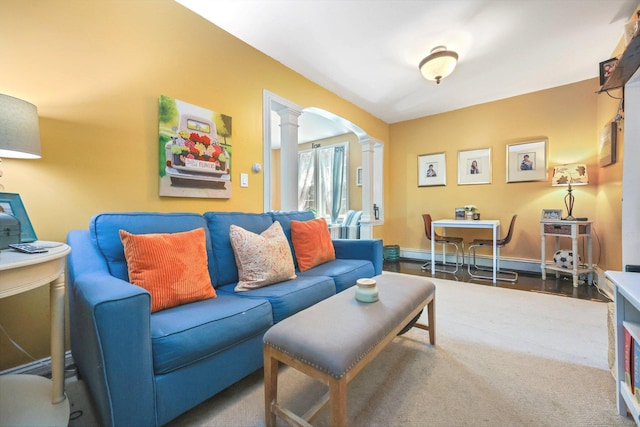 living room featuring ornate columns and a baseboard radiator