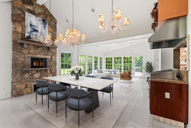 tiled dining area featuring lofted ceiling, a stone fireplace, and a chandelier