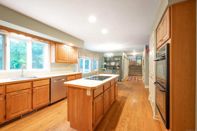 18 Hunters Ridge Rd, Southbury, CT 06488 - kitchen with a sink, black appliances, a chandelier, a center island, and light countertops