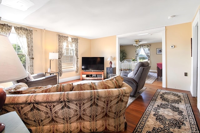 living room featuring hardwood / wood-style floors and ceiling fan