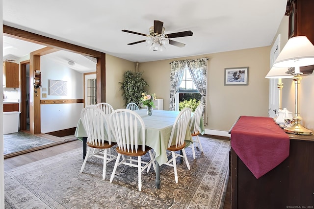 dining area featuring ceiling fan, dark hardwood / wood-style flooring, and vaulted ceiling