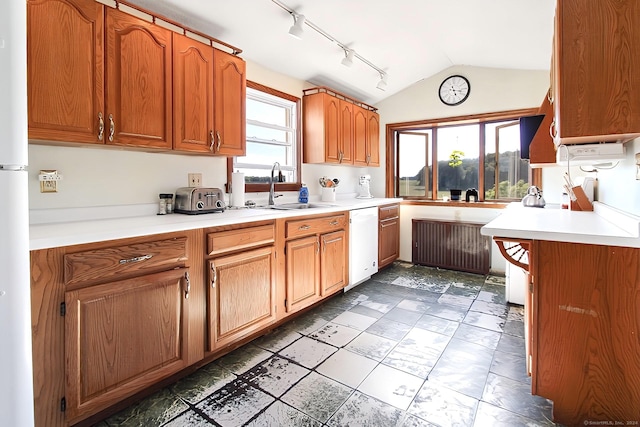 kitchen featuring white appliances, plenty of natural light, lofted ceiling, and sink