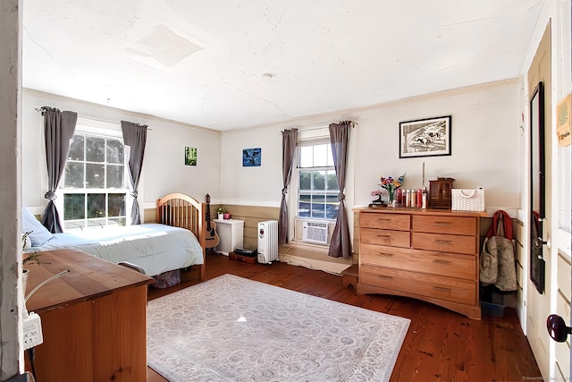 bedroom with cooling unit, dark hardwood / wood-style flooring, and crown molding