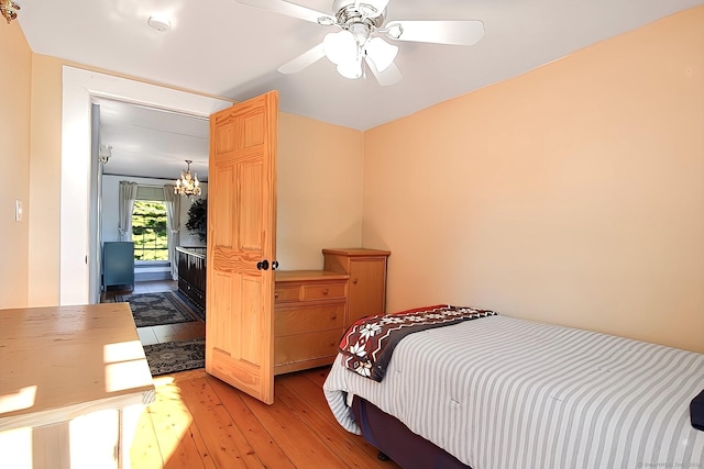 bedroom with ceiling fan and light hardwood / wood-style floors