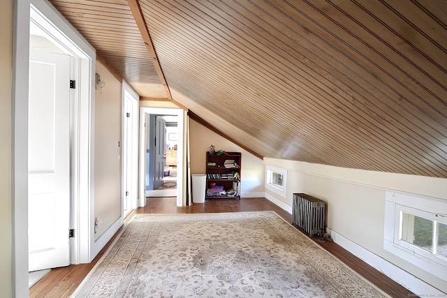 additional living space with wooden ceiling, radiator heating unit, wood-type flooring, and vaulted ceiling