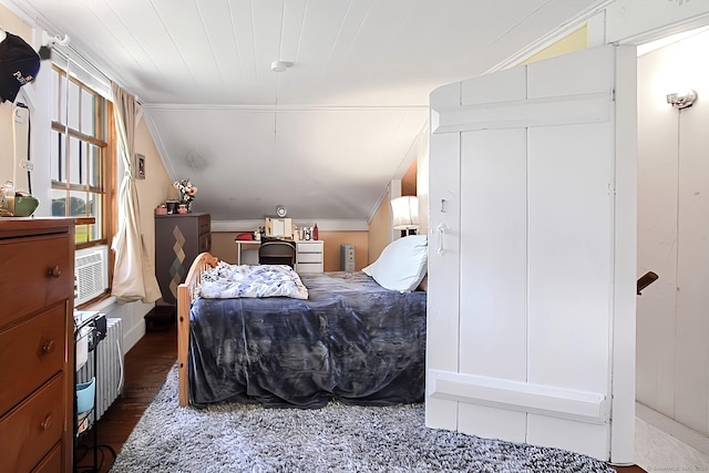 bedroom with crown molding, dark hardwood / wood-style floors, and vaulted ceiling